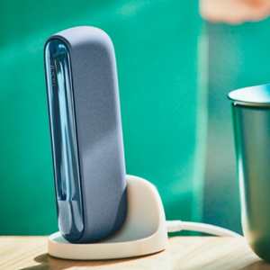 An IQOS ILUMA Pocket Charger in a charging station.